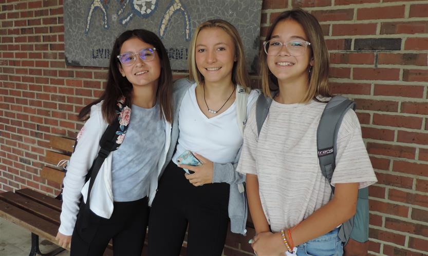 Three girls smile